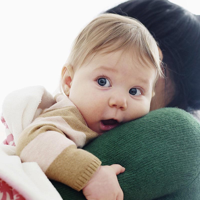 Baby held by an adult