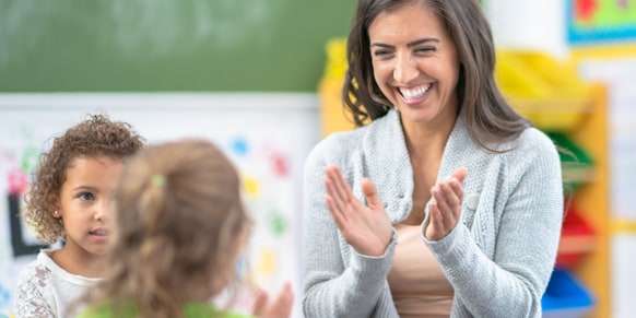 Teacher clapping with students