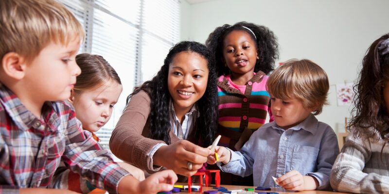 Students building with blocks on table