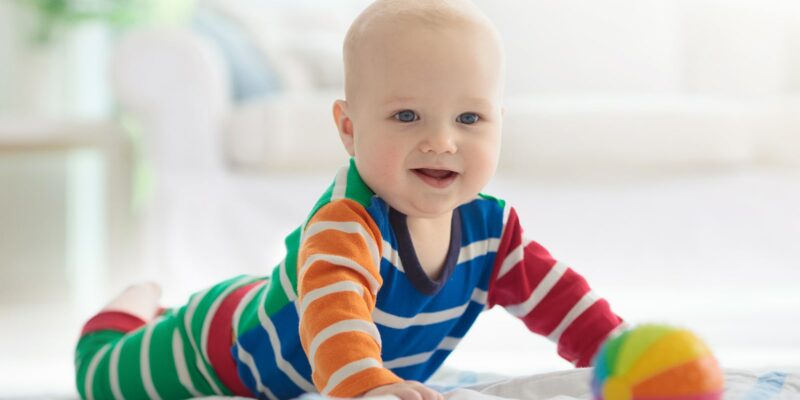 A baby pushing up off the ground