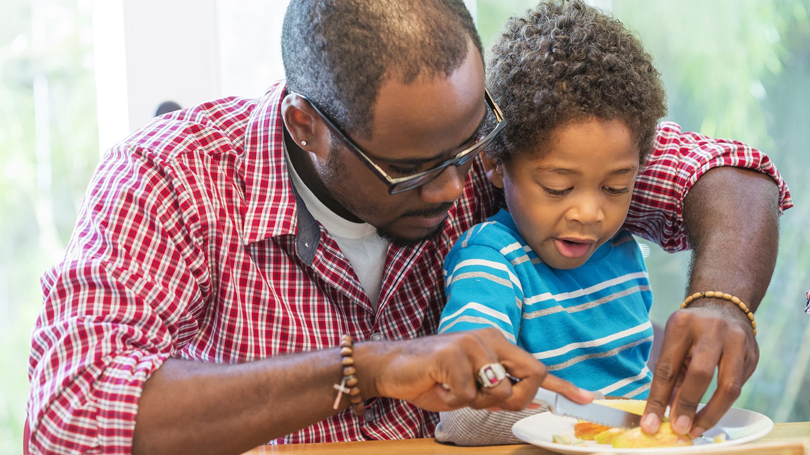 Parent helping child make a healthy snack