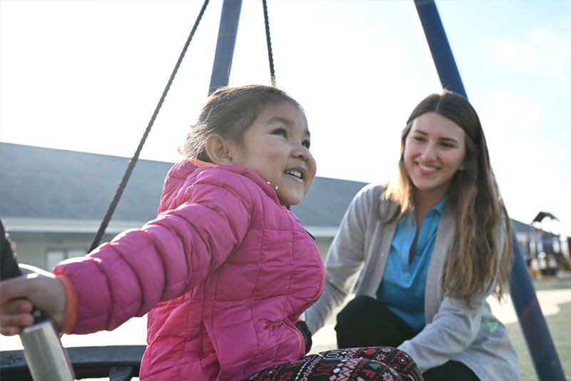 Girl playing on swingset