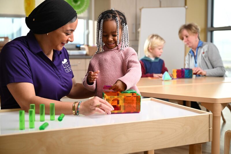 Child playing with teacher