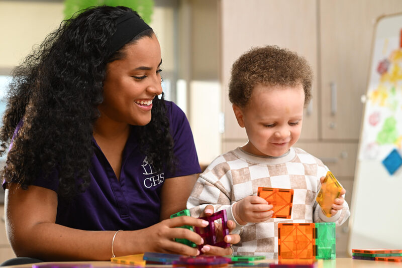 Teacher and child building with blocks