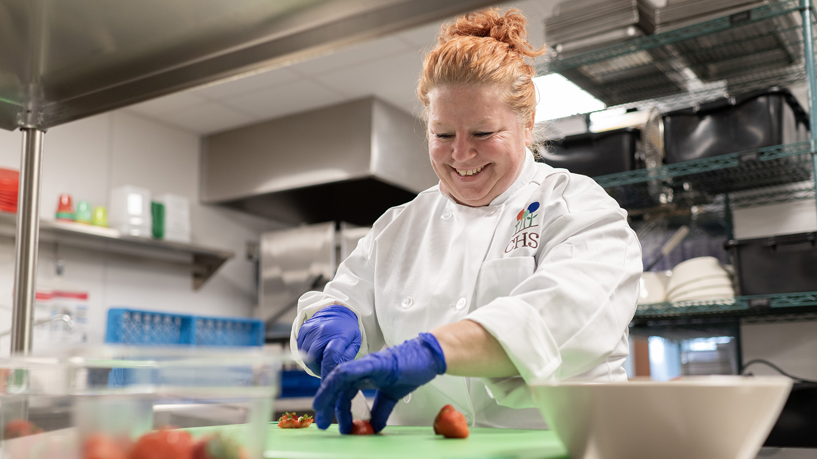 CHS team member preparing food items